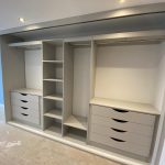 wardrobe interior - grey with shelves, hanging rails and drawers