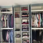 Bespoke wardrobe interior with clothes hanging rails, fixed shelving and top shelves