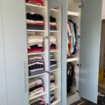 Interior of wardrobe with shelves and mirror - White