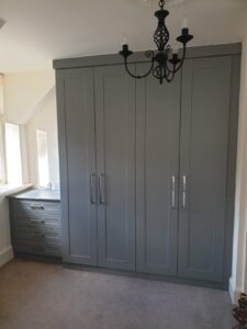 bespoke fitted shaker style wardrobes with a matching chest of four drawers. Dust grey colour finish