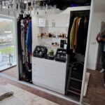 Premium glass shelves in a wardrobe paired with lighting for showcasing decorative items or accessories.