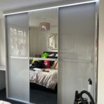 made-to-measure sliding door wardrobe with glossy grey coloured glass by Creative Joinery Chorley