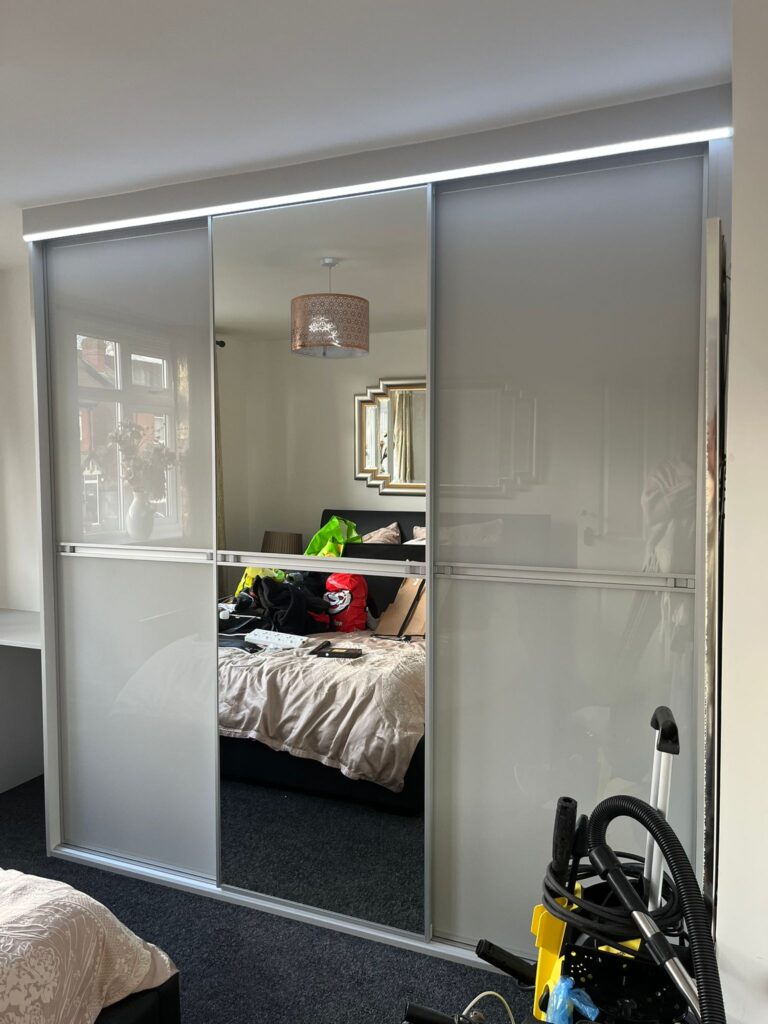 made-to-measure sliding door wardrobe with glossy grey coloured glass by Creative Joinery Chorley