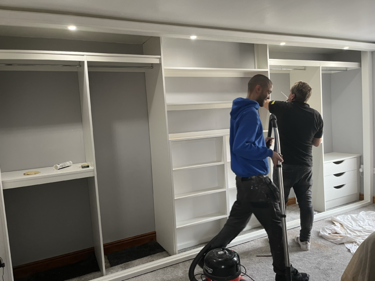 Creative Joinery's in house fitters fitting a bespoke sliding wardrobe interior