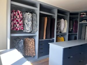 Bespoke open dressing room with hanging rails, shelving, drawer units and central island – custom fitted by Creative Joinery Chorley