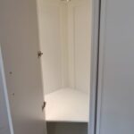 Corner wardrobe interior with curved bar rail