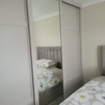 Shaker Slide sliding door wardrobes in Cashmere.