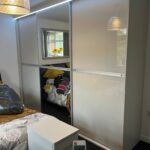 custom size sliding doors with glossy grey coloured glass by Creative Joinery Chorley