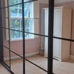 Crittal effect fitted sliding door wardrobes, four doors, in the colour black