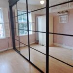 Crittal effect fitted sliding door wardrobes, four doors, in the colour black