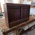 Sliding cupboard doors in a walnut colour finish