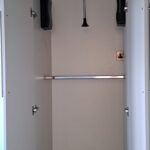 Accessible wardrobe pull-down hanging rail lowered to reachable height.