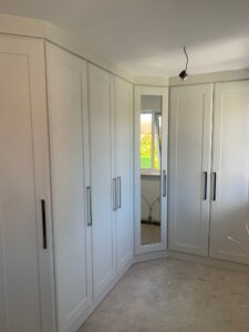 Fitted Shaker wardrobes round a corner