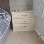 Free standing bedside table with three drawers.
