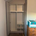 Angled wardrobe in alcove - Interior with shelves and hanging rails - White