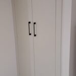 2 Door white wardrobe with black handles in loft conversion eaves