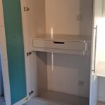 2 door white wardrobe with hanging rail, shelves, and single drawer