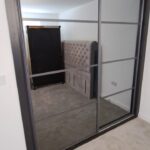 Bespoke sliding door wardrobe with grey tinted mirrors, two doors