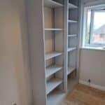 interior of light grey wardrobe with adjustable shelving