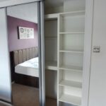 Interior of wardrobe with hanging rails and shelving - White with mirrors