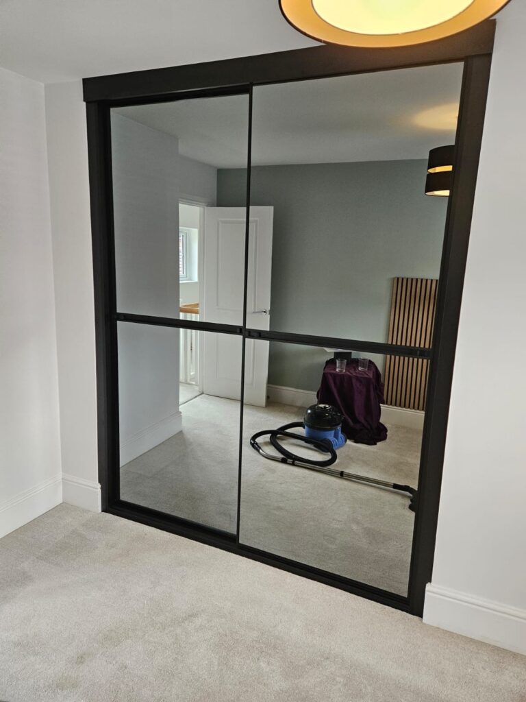 Bespoke fitted sliding door wardrobes with grey tinted mirrors - minimal and sophisticated
