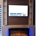 Fitted media wall in a living room with an electric fire