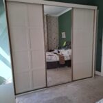 3 door white sliding door wardrobe with centre mirror and corner shelving