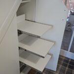 Pull-out wardrobe shoe rack for easy-access footwear organisation.