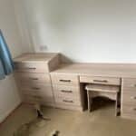 Oak custom fitted dressing table with beveled edge drawers in a light cream wood greain finish