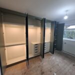 Wardrobe hanging rails fitted beneath a top shelf for everyday clothing storage