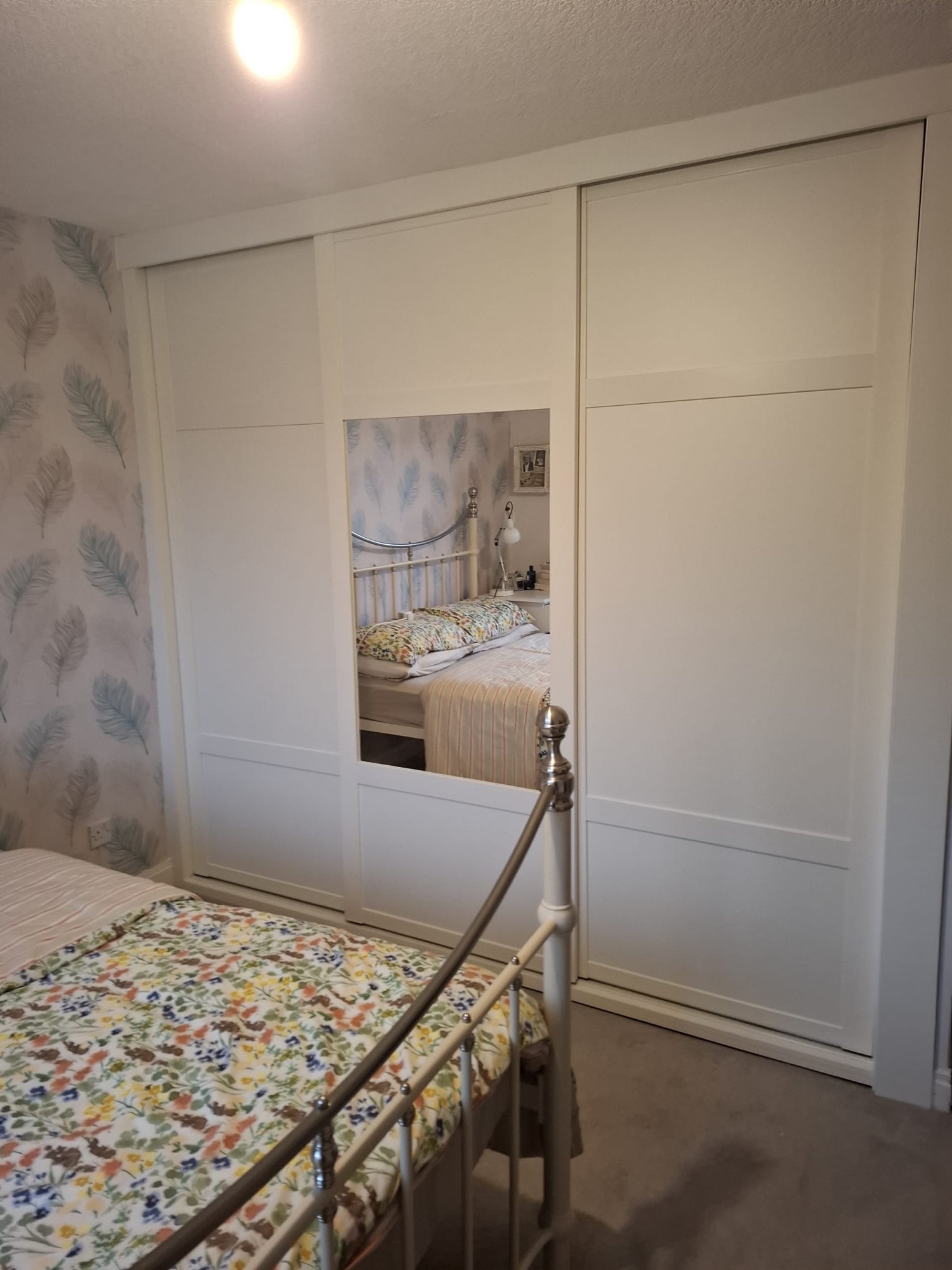 made-to-measure fitted sliding door wardrobe with one split mirror sliding door and two solid panel sliding doors