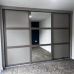 Fitted shaker sliding door wardrobes with two tone neutralfinish