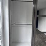 Open wardrobe interior with a bar rail fitted without a top shelf for maximum hanging height.