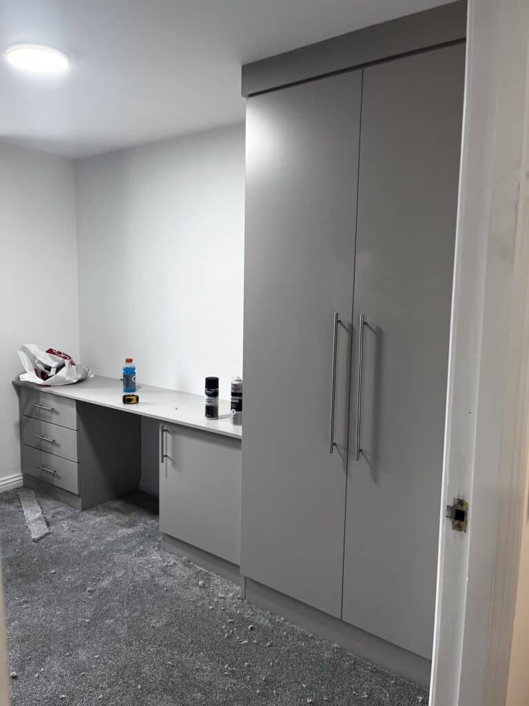 Fitted double wardrobe and desk with one set of three drawers and one cupboard