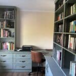 Fitted home office with a curved desk, drawers, cupboard and adjsutable shelving. Everything is in the colour Reed Green