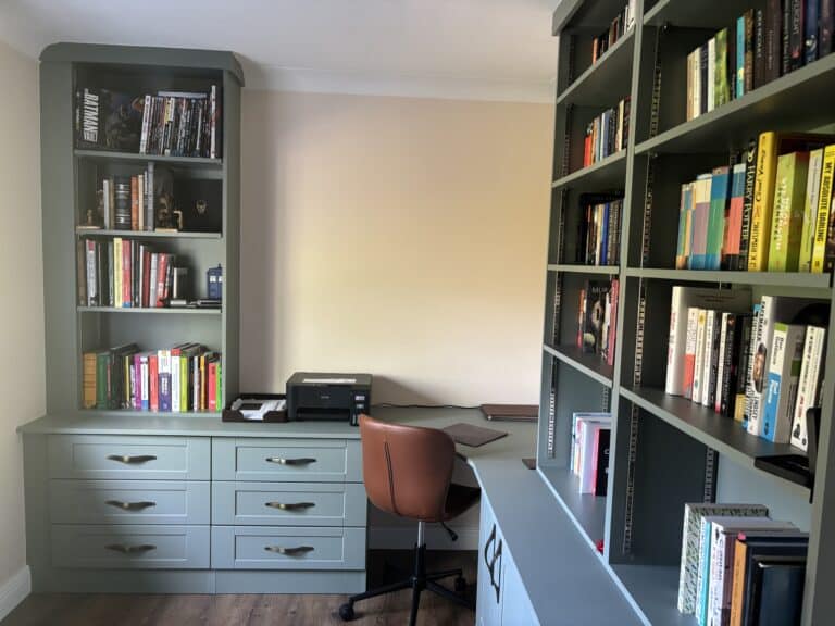 Fitted home office with a curved desk, drawers, cupboard and adjsutable shelving.