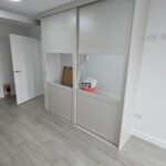 made-to-measure stand alone sliding door wardrobe in the colour Cashmere with a mirror in the centre of each door