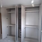 Fitted wardrobe interior with hanging space, shelving and drawers.
