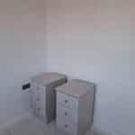 Two stand alone slim bedside tables, each with three drawers. Knob handles are fitted to the centre of each drawer. The colour is Cashmere Grained