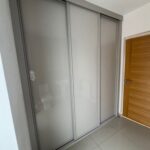 Fitted sliding door wardrobe with three doors. The doors have a Cashmere coloured frame and are all fitted with Cashmere coloured glass.
