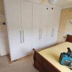 Three double Shaker style bespoke wardrobes in the colour white.