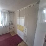 Picture of an undecorated wall. The picture shows the space where wardrobes will be fitted.