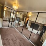 Custom L-Shape corner sliding wardrobe with mirrored wardrobe doors bby Creative Joinery