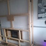 progress of the building of a custom media wall with fire intergration ready for fitting acoustic wall panelling