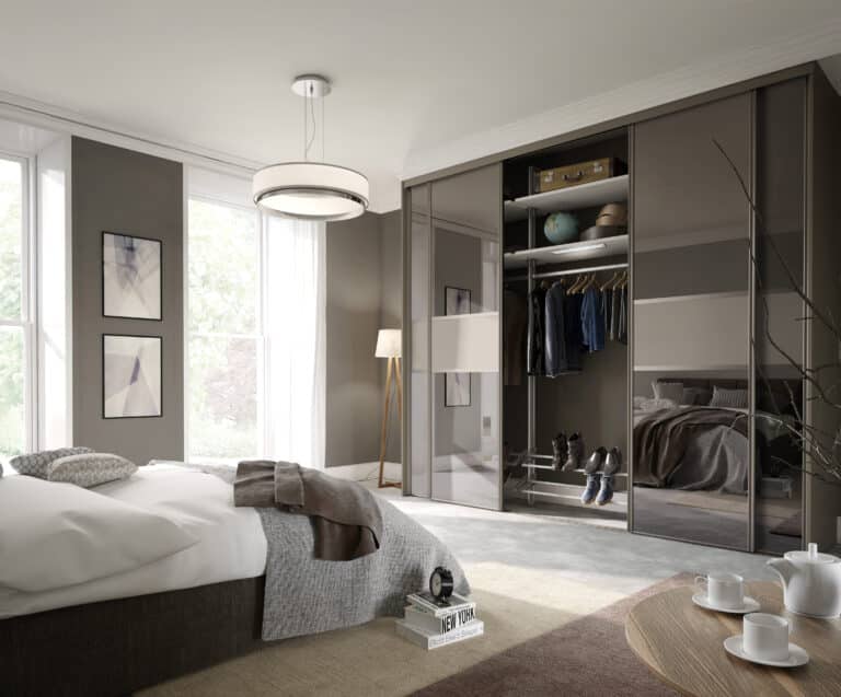 Pebble Grey Harrison Monarch sliding door wardrobe featuring Bronze Tinted Mirror panels in a modern bedroom interior.