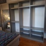 Interior of White and Grey Wardrobe With Shelves and Rails