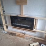 progress of the building of a custom media wall with fire intergration ready for fitting acoustic wall panelling
