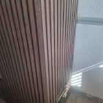 progress of the building of a custom media wall with cut out for electric sockets and acoustic wall panelling
