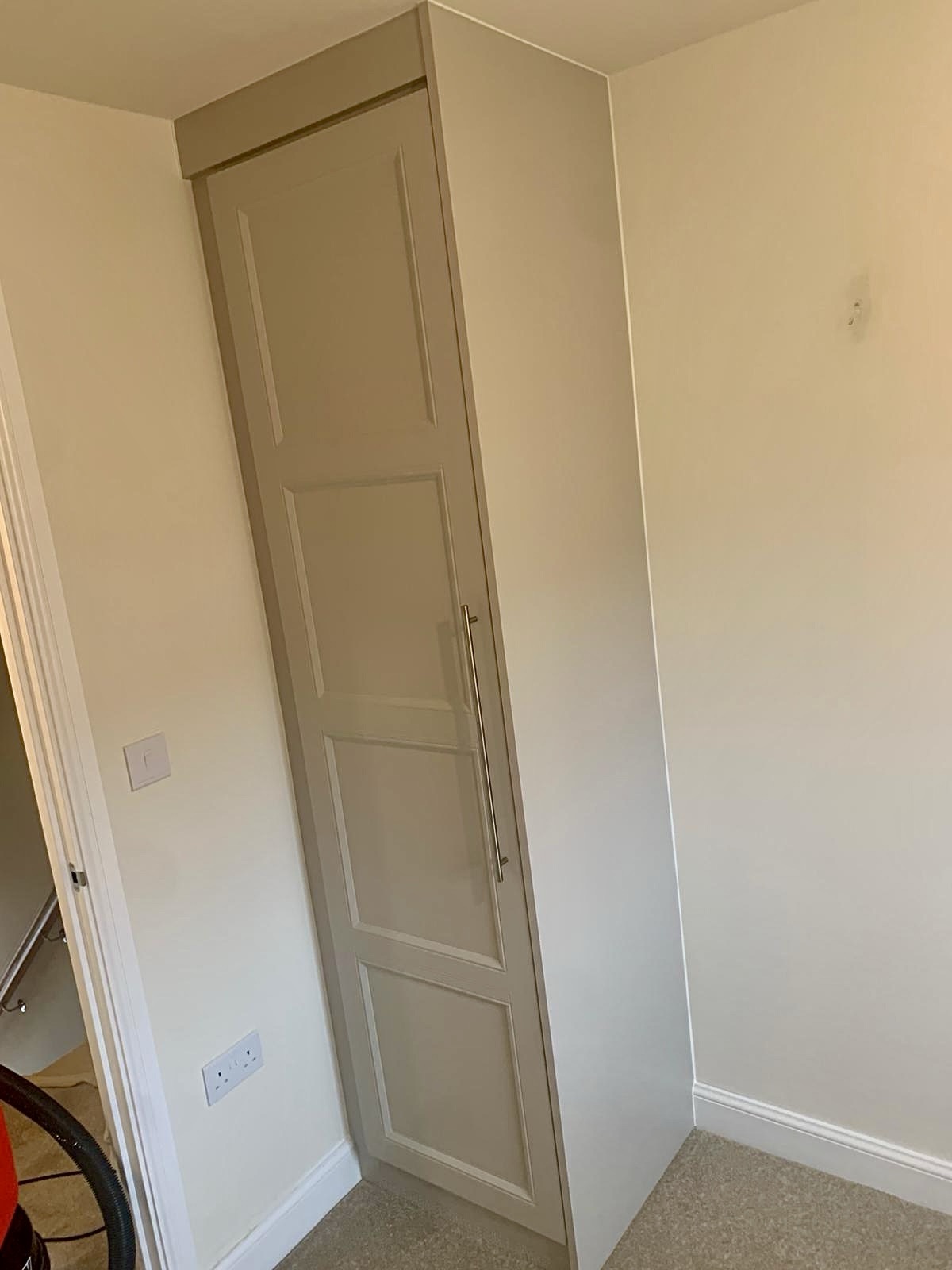Small single custom wardrobe in the colour Cashmere with a Shaker style wardrobe door
