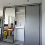 Accessible wardrobe pull-down hanging rail lowered to reachable height.